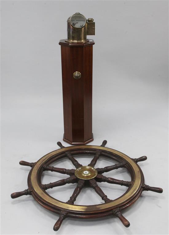 A teak eight spoke ships wheel on an octagonal mahogany column, 43.5in.